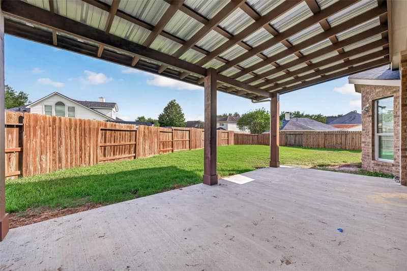 The covered patio off the back of the house, looking out over the yard