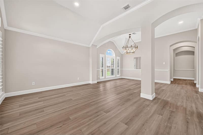 Dining room with a chandelier and an arched window