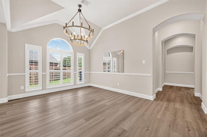 Carpeted upstairs flex room with a vaulted ceiling